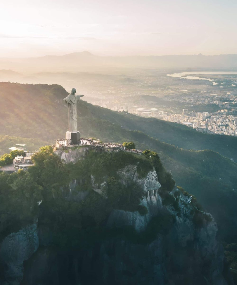 Rio de Janeiro, Brazil - May 3, 2022: Aerial view of Christ the Redeemer Statue on top of Corcovado Mountain and downtown Rio - Rio de Janeiro, Brazil