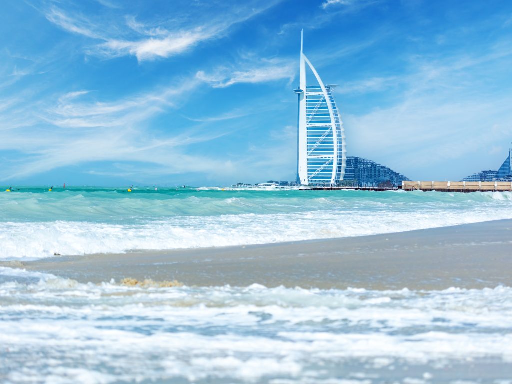 Burj Al Arab hotel in Dubai UAE view from the sea and beach. Luxurious tourist destination