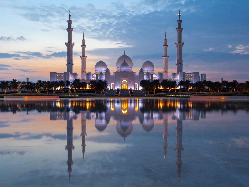 Sheikh Zayed Mosque in Abu Dhabi, UAE, at dusk with reflection in the water